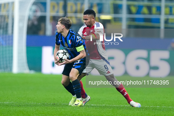 Nicolo' Barella of FC Internazionale and Gabriel Jesus of Arsenal compete for the ball during the UEFA Champions League 2024/25 League Phase...