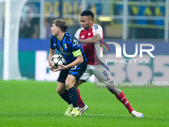 Nicolo' Barella of FC Internazionale and Gabriel Jesus of Arsenal compete for the ball during the UEFA Champions League 2024/25 League Phase...