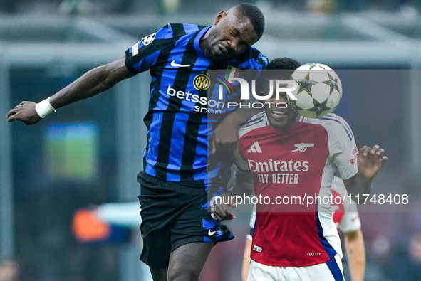 Thomas Partey of Arsenal and Marcus Thuram of FC Internazionale jump for the ball during the UEFA Champions League 2024/25 League Phase MD4...