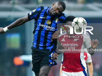 Thomas Partey of Arsenal and Marcus Thuram of FC Internazionale jump for the ball during the UEFA Champions League 2024/25 League Phase MD4...