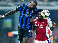 Thomas Partey of Arsenal and Marcus Thuram of FC Internazionale jump for the ball during the UEFA Champions League 2024/25 League Phase MD4...