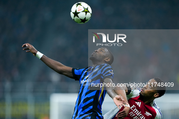 Jurrien Timber of Arsenal and Marcus Thuram of FC Internazionale jump for the ball during the UEFA Champions League 2024/25 League Phase MD4...