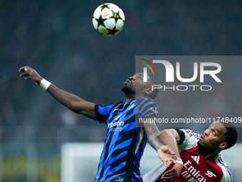 Jurrien Timber of Arsenal and Marcus Thuram of FC Internazionale jump for the ball during the UEFA Champions League 2024/25 League Phase MD4...