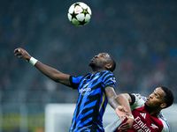 Jurrien Timber of Arsenal and Marcus Thuram of FC Internazionale jump for the ball during the UEFA Champions League 2024/25 League Phase MD4...