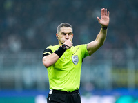 Referee Istvan Kovacs gestures during the UEFA Champions League 2024/25 League Phase MD4 match between FC Internazionale and Arsenal at Stad...