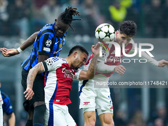 Kai Havertz of Arsenal and Yann Aurel Bisseck of FC Internazionale jump for the ball during the UEFA Champions League 2024/25 League Phase M...