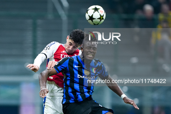 Kai Havertz of Arsenal and Yann Aurel Bisseck of FC Internazionale jump for the ball during the UEFA Champions League 2024/25 League Phase M...