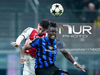 Kai Havertz of Arsenal and Yann Aurel Bisseck of FC Internazionale jump for the ball during the UEFA Champions League 2024/25 League Phase M...