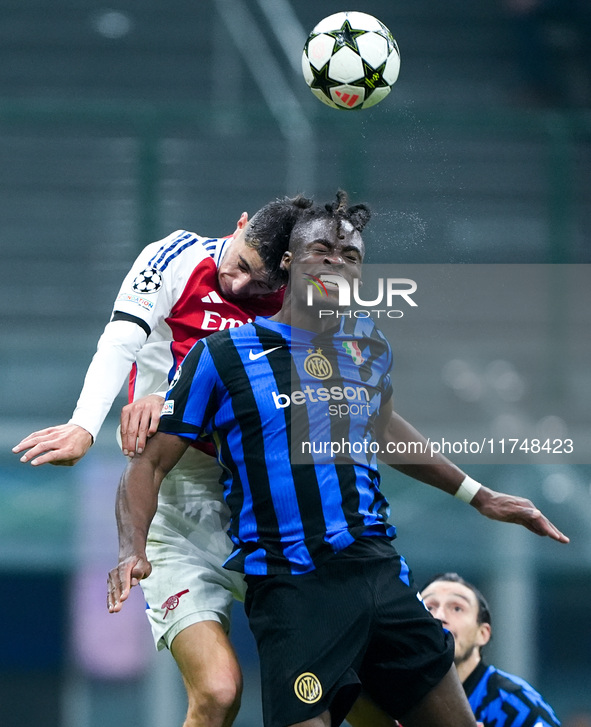 Kai Havertz of Arsenal and Yann Aurel Bisseck of FC Internazionale jump for the ball during the UEFA Champions League 2024/25 League Phase M...