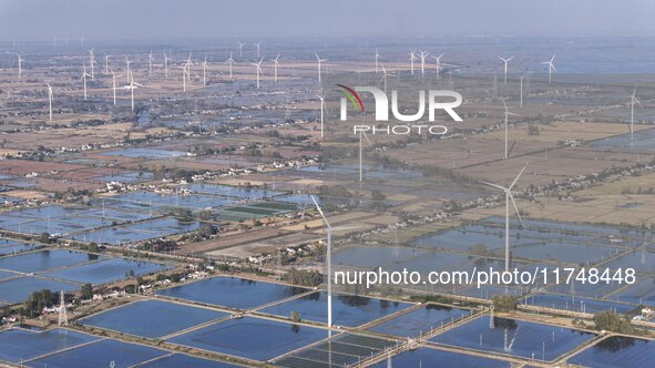 An aerial photo shows a new energy wind power generation near Gaoyou Lake in Taji town of Huai'an City, East China's Jiangsu province, on No...