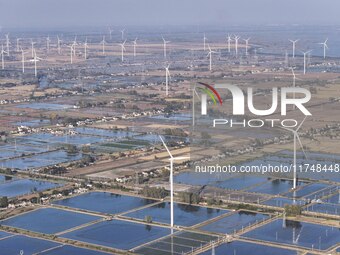 An aerial photo shows a new energy wind power generation near Gaoyou Lake in Taji town of Huai'an City, East China's Jiangsu province, on No...