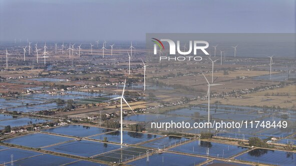 An aerial photo shows a new energy wind power generation near Gaoyou Lake in Taji town of Huai'an City, East China's Jiangsu province, on No...