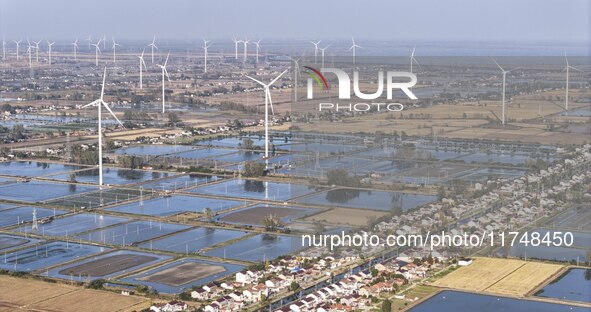 An aerial photo shows a new energy wind power generation near Gaoyou Lake in Taji town of Huai'an City, East China's Jiangsu province, on No...