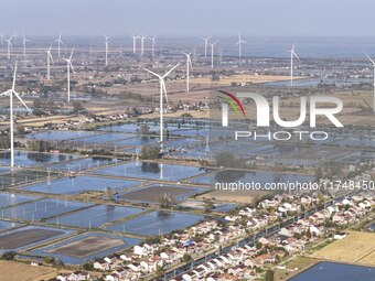 An aerial photo shows a new energy wind power generation near Gaoyou Lake in Taji town of Huai'an City, East China's Jiangsu province, on No...