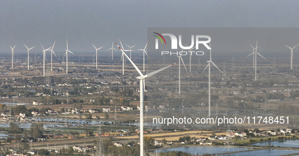 An aerial photo shows a new energy wind power generation near Gaoyou Lake in Taji town of Huai'an City, East China's Jiangsu province, on No...