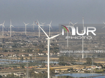 An aerial photo shows a new energy wind power generation near Gaoyou Lake in Taji town of Huai'an City, East China's Jiangsu province, on No...