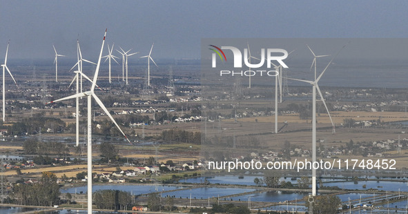 An aerial photo shows a new energy wind power generation near Gaoyou Lake in Taji town of Huai'an City, East China's Jiangsu province, on No...