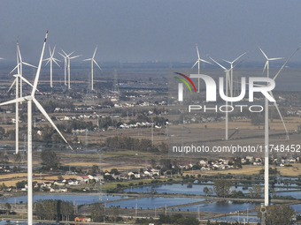 An aerial photo shows a new energy wind power generation near Gaoyou Lake in Taji town of Huai'an City, East China's Jiangsu province, on No...