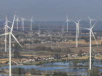 An aerial photo shows a new energy wind power generation near Gaoyou Lake in Taji town of Huai'an City, East China's Jiangsu province, on No...