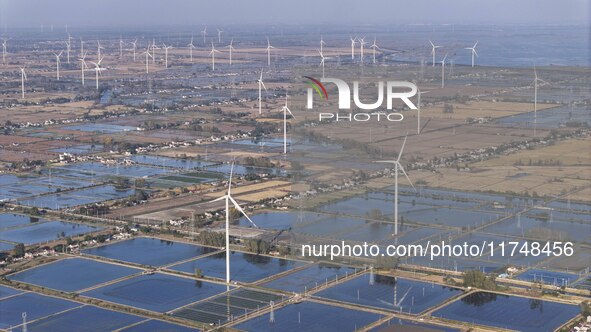 An aerial photo shows a new energy wind power generation near Gaoyou Lake in Taji town of Huai'an City, East China's Jiangsu province, on No...