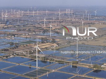 An aerial photo shows a new energy wind power generation near Gaoyou Lake in Taji town of Huai'an City, East China's Jiangsu province, on No...