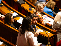 Gabriel Attal, President of the Ensemble pour la Republique parliamentary group, looks on as Prisca Thevenot, deputy of the Ensemble pour la...