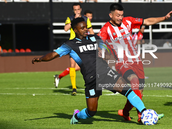 Johan Carbonero of Racing Club competes for the ball against a player from Barracas Central during a Liga Profesional 2024 match between Bar...