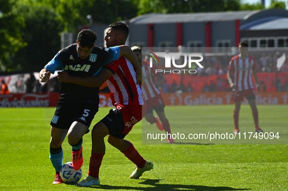 Juan Ignacio Nardoni of Racing Club competes for the ball against Nicolas Tolosa of Barracas Central during a Liga Profesional 2024 match be...