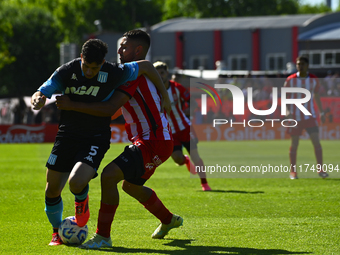 Juan Ignacio Nardoni of Racing Club competes for the ball against Nicolas Tolosa of Barracas Central during a Liga Profesional 2024 match be...