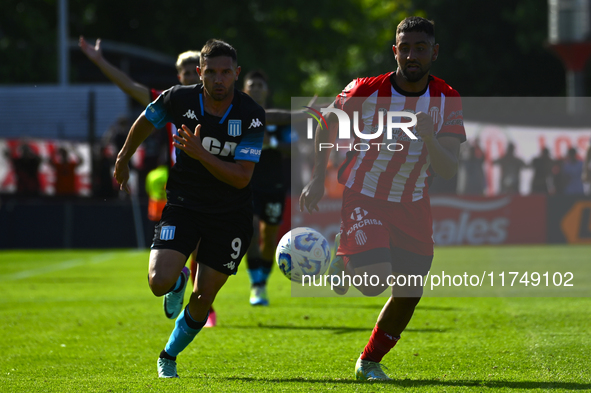 Adrian Martinez of Racing Club competes for the ball against Nicolas Tolosa of Barracas Central during a Liga Profesional 2024 match between...