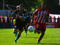 Adrian Martinez of Racing Club competes for the ball against Nicolas Tolosa of Barracas Central during a Liga Profesional 2024 match between...