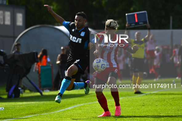 Adrian Martinez of Racing Club competes for the ball against Rodrigo Insua of Barracas Central during a Liga Profesional 2024 match between...