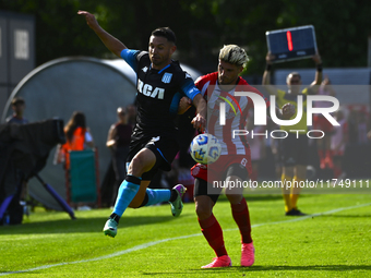 Adrian Martinez of Racing Club competes for the ball against Rodrigo Insua of Barracas Central during a Liga Profesional 2024 match between...