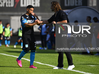 Insua, coach of Barracas Central, greets Maximiliano Salas during a Liga Profesional 2024 match between Barracas Central and Racing Club at...