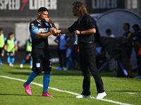 Insua, coach of Barracas Central, greets Maximiliano Salas during a Liga Profesional 2024 match between Barracas Central and Racing Club at...