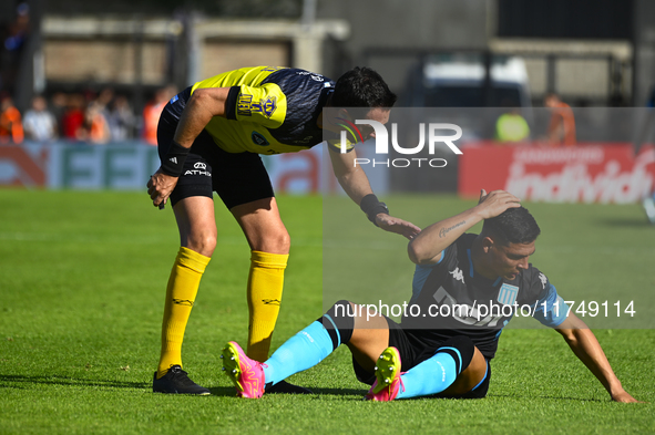 The referee Pablo Dovalo and Maximiliano Salas gesture during a Liga Profesional 2024 match between Barracas Central and Racing Club at Guil...