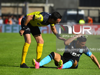 The referee Pablo Dovalo and Maximiliano Salas gesture during a Liga Profesional 2024 match between Barracas Central and Racing Club at Guil...