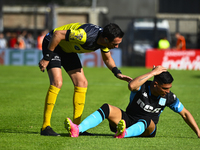 The referee Pablo Dovalo and Maximiliano Salas gesture during a Liga Profesional 2024 match between Barracas Central and Racing Club at Guil...