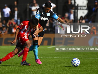 Maximiliano Salas of Racing Club competes for the ball against Maximiliano Puig of Barracas Central during a Liga Profesional 2024 match bet...