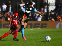 Maximiliano Salas of Racing Club competes for the ball against Maximiliano Puig of Barracas Central during a Liga Profesional 2024 match bet...