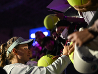 RIYADH, SAUDI ARABIA - NOVEMBER 06: Elena Rybakina of Kazakhstan signs autographs for her fans after her match against Aryna Sabalenka of Be...