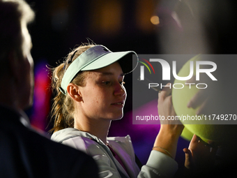 RIYADH, SAUDI ARABIA - NOVEMBER 06: Elena Rybakina of Kazakhstan signs autographs for her fans after her match against Aryna Sabalenka of Be...