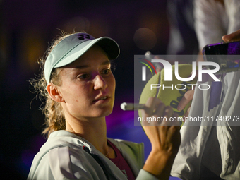 RIYADH, SAUDI ARABIA - NOVEMBER 06: Elena Rybakina of Kazakhstan signs autographs for her fans after her match against Aryna Sabalenka of Be...