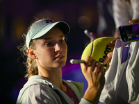 RIYADH, SAUDI ARABIA - NOVEMBER 06: Elena Rybakina of Kazakhstan signs autographs for her fans after her match against Aryna Sabalenka of Be...