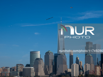 A small plane towing a sign that reads ''We hold democracy together'' flies over New York, U.S., on November 6, 2024. (