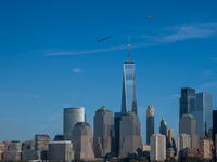 A small plane towing a sign that reads ''We hold democracy together'' flies over New York, U.S., on November 6, 2024. (