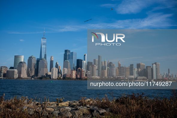 A small plane towing a sign that reads ''We hold democracy together'' flies over New York, U.S., on November 6, 2024. 