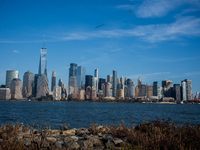 A small plane towing a sign that reads ''We hold democracy together'' flies over New York, U.S., on November 6, 2024. (