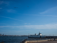 A small plane towing a sign that reads ''We hold democracy together'' flies over New York, U.S., on November 6, 2024. (