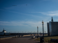 A small plane towing a sign that reads ''We hold democracy together'' flies over New York, U.S., on November 6, 2024. (